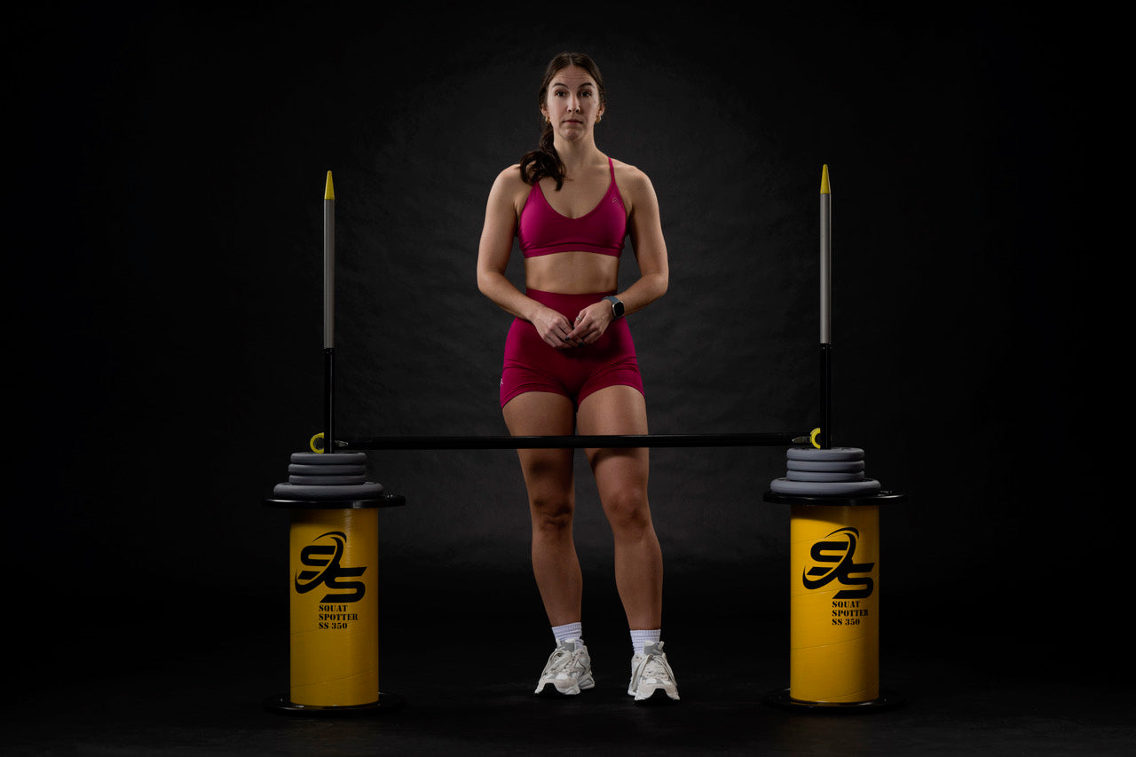 Athlete with squat spotter front view