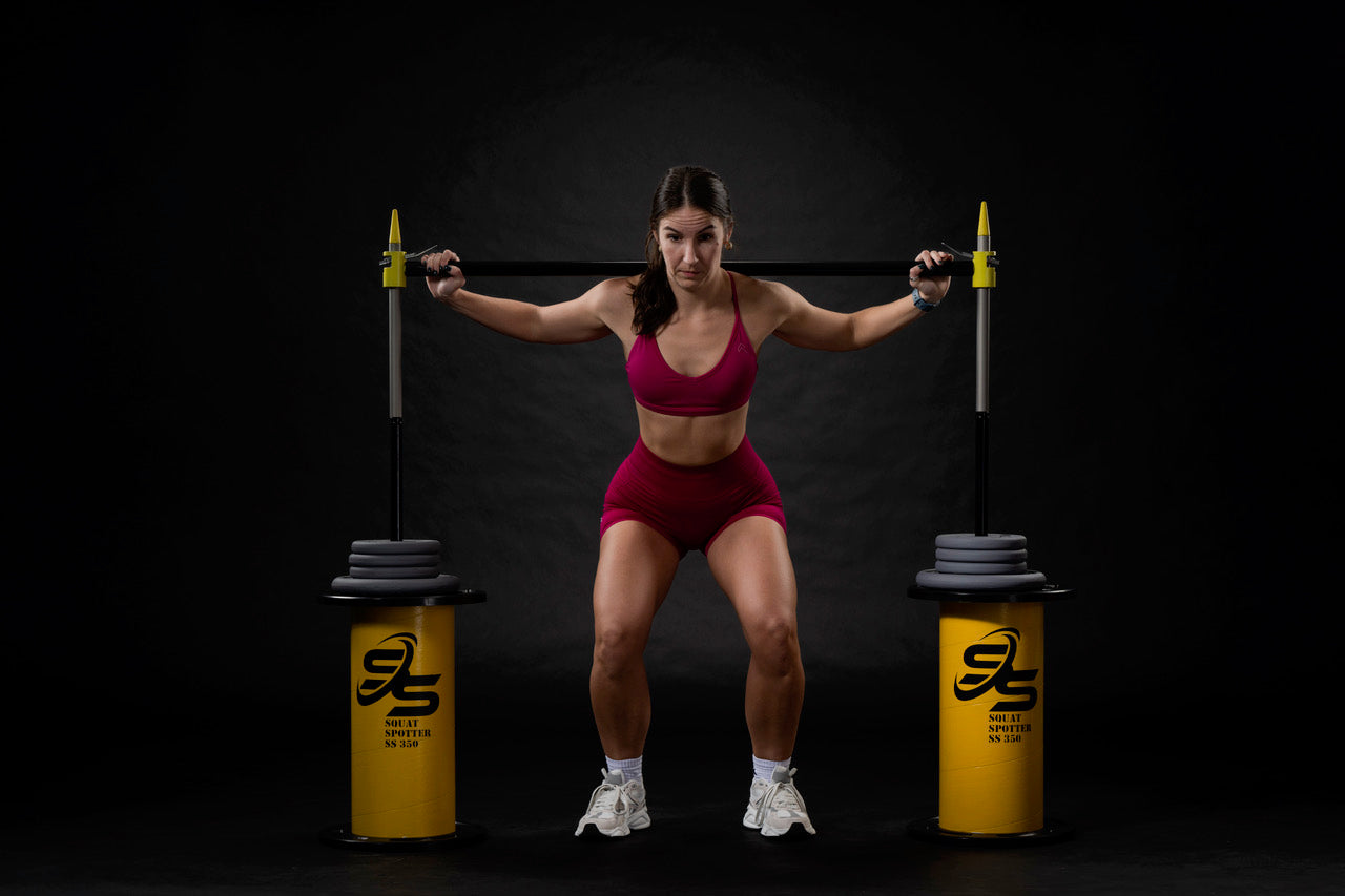 Athlete with squat spotter set up position