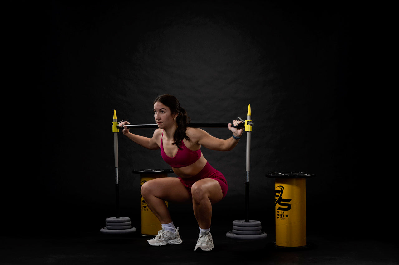 Athlete using squat spotter end position